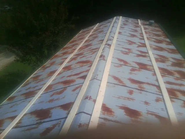 Rusted metal roof panels with new wood purlins before replacement — Storm Damage Roof Repair in Valrico by Roofing Brothers